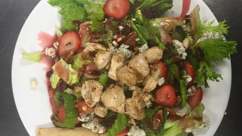Raspberry · Lettuce blend, tomatoes, cucumbers, cranberries, candied pecans, strawberries, bleu cheese crumbles, boiled egg, and raspberry vinaigrette.