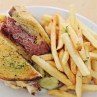 Peter Paul Reuben · Corned beef, sauerkraut, and melted Holland cheese, piled on grilled rye. Served with pommes...