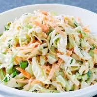 Coleslaw · Crunchy cabbage with carrots tossed in a vinegar dressing.