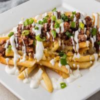 Brisket Fries · Smoked moist brisket over fries with shredded cheese blend,  BBQ sauce, and garnished with s...