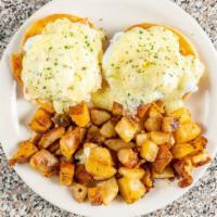 Eggs Benedict · Two poached eggs over English muffins, topped with hollandase, served with homefries.