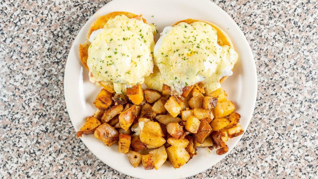 Eggs Benedict · Two poached eggs over English muffins, topped with hollandase, served with homefries.