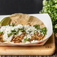16 Carnita · TENDER BRAISED SPICED PORK TOPPED WITH QUESO FRESCO, FRESH ONION, AND CILANTRO WITH A SLICE ...