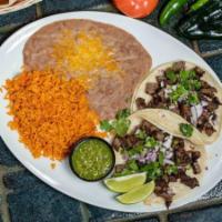 Tacos Al Pastor · Tacos Al Pastor- Two soft corn tortillas filled with grilled steak, diced red onions, fresh ...
