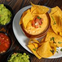 Chile Con Queso Dip · Chile con Queso Dip-  Blend of cheeses, chilies, spices, and Dos Equis Ambar. Served with co...
