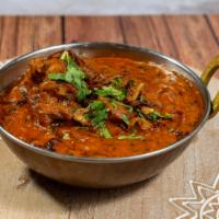 Murgh Masala · Chicken legs cooked on the bone in a spicy tomato, onion gravy, cashew paste and spices.