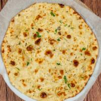 Garlic Naan · Flat bread with garlic and fresh herbs baked in tandoor oven.