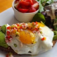 Avocado Toast · Made with wheat toast topped with avocado purée, fresh avocado, salsa and eggs. Served with ...