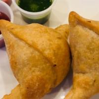 Vegan Samosas · Hand rolled pastry, filled with savory filling of potatoes and green peas, served with chutn...