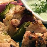 Chicken Malai Kebab · 2 Skewers of Chicken, marinated in Cream and cardamom, with grilled veggies, served with yog...