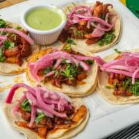 Al Pastor · Five homemade Al Pastor tacos. Topped with onions, cilantro, limes, and salsa Verde.