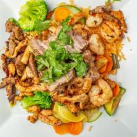 Paella De La Casa · Spaniard dish in a Mexican way.  Grilled steak, grilled chicken, Carnitas and Shrimp on a be...