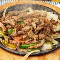 Fajita Steak · Grilled steak. A sizzling skillet, topped with green peppers, onions and tomatoes. Accompani...