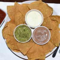 Trio Dip · Our three tasty dips- refried beans, queso, and guacamole.