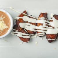 Plantains  · Fried ripe plantains served with refried beans and drizzled with sour cream.