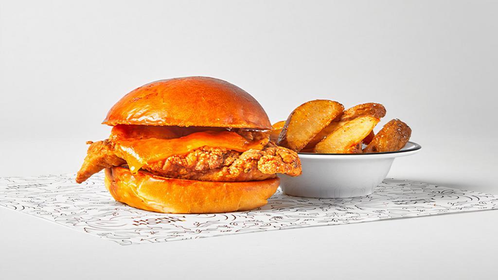 Kids Crispy Chicken Sandwich · crispy chicken breast on a brioche bun with no sauces or condiments, served with a side of fries.