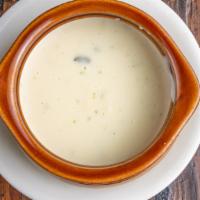 Queso Con Chile · Spicy white cheese dip. Served with corn chips on the side.