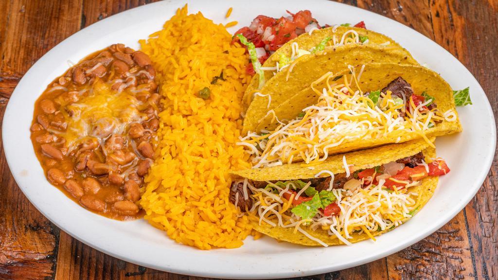 Tacos Al Carbon · Three soft fresh flour tortillas, filled with choice of meat. Served with Mexican rice, refried beans, sour cream, pico de gallo and Mexican butter on the side.