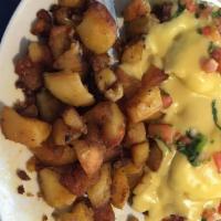 Mesa · Two poached eggs with corn beef hash on a toasted English muffin, topped with hollandaise sa...