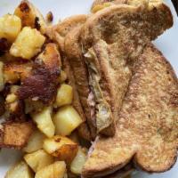 Monte Cristo · Triple-decker French toast stuffed with ham, sausage and cheese, served with home fries.