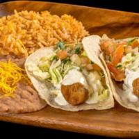Two Fish Tacos · Two fish tacos with tartar sauce, pico de gallo, and cabbage. Served with rice and beans.