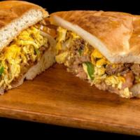 Machaca Torta · Shredded beef, egg, bell peppers, tomatoes, onions, beans, and cheese.