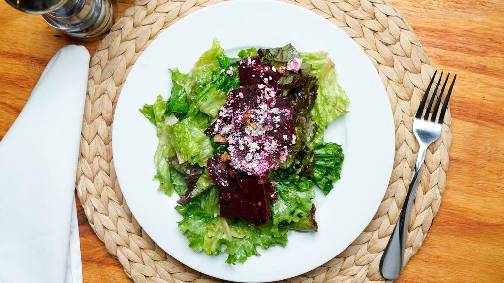 Beet Salad · Fresh beets roasted walnuts, blue cheese served on a bed of greens with shallot balsamic vinaigrette.