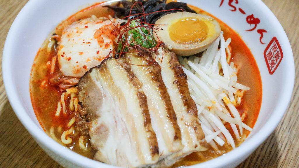 Spicy Ramen · Natural Heritage Berkshire Pork bone soup (tonkotsu) with chicken and seafood broth with wavy egg noodle topped with roast pork (charshu), kimchee, kikurage mushroom, bean sprout, scallion, and seasoned boiled egg.