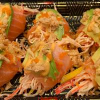 Dancing Salmon · Salmon belly rolls with mango,spicy crab.top avocado,masago and crispy onion. Spicy mayo,pok...