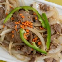 B 4. Mongolian Beef · Sices of tender beef stir-fried bamboo shoots green scallion in a dark sauce.