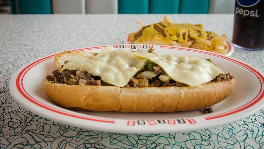 Philly Cheesesteak · Six ounces of Philly steak topped with swiss cheese, grilled onions, and green peppers on an eight-inch sub bun.