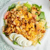 Crispy Chicken Salad · Crispy fried chicken tenders atop crisp romaine lettuce, topped with Swiss and American chee...
