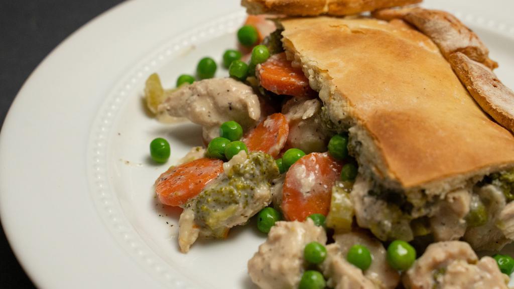 Chicken Pot Pie · Bright vegetables cooked low and slow, dressed in a warm creamy pot pie sauce topped with golden gluten-free crust. Calories: 479, carbohydrates: 34 g, fiber: 7 g, protein: 48 g, and fats: 18 g.