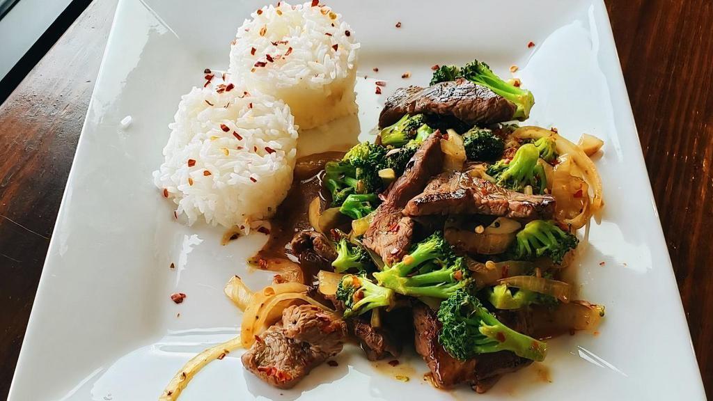 Beef & Broccoli · Lightly seared steak and broccoli covered in a thick ginger sauce served beside a bed of rice.