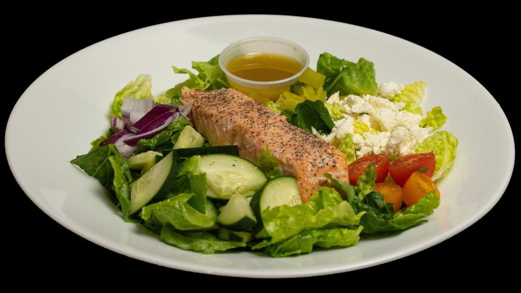 Salmon Greek Salad · Crunchy, organic romaine lettuce, all the classic Greek salad ingredients with a yummy house-made dressing! Topped with a clean, delicious salmon filet. Calories: 370, carbohydrates: 11 g, fiber: 3 g, protein: 30 g, and fats: 23 g.