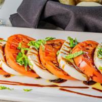 Caprese Salad · Vegetarian. Sliced Roma tomatoes, mozzarella, and basil with balsamic reduction and extra vi...
