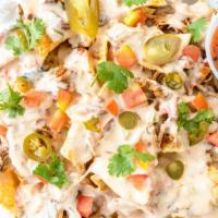 Adobo Chicken Nachos · Slow roasted chicken in a semi spicy sauce with adobo peppers, tomatoes, onions, jalapeños t...