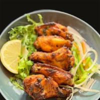 Tikkalicious Wings · 6 chicken wings marinated in Indian herbs, cooked in clay pot oven.