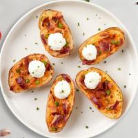 Cheesy Bacon Skins · (6 pieces) Baked potato skins filled with cheddar cheese, bacon, and chives. Served with sou...