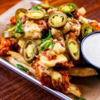 Loaded Boneless Wings · Tossed in your favorite sauce served over a bed of french fries topped with queso, cheddar &...