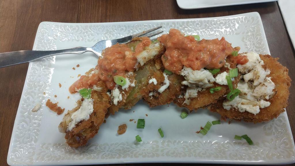 Fried Green Tomatoes · Topped withBoursin cheese, tomato basil cream sauce and lump crab meat.