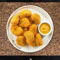 International Court Of Chicken Nuggets · Bite sized nuggets of chicken breaded and fried until golden brown. Served with your choice ...