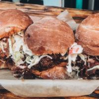 Reuben Sliders · Our famous brisket topped with house-made pickle slaw and gruyere cheese.