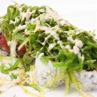 Poky Roll · In: spicy tuna roll. Out: topped with seaweed salad mix and special sauce.