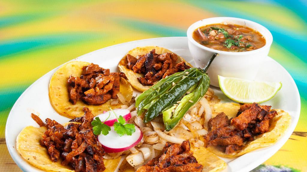Street Tacos (5) · (Beef Fajita & Chicken Fajita) Mini Corn Tortilla Tacos with Charro Beans, Grilled Onions, and Fried Jalapeño.
 (Pastor,Lengua & Baebacoa) comes with cilantro & onions. With Charro Beans, and fried Jalapeño.