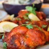 Tandoori Chicken(G) · Chicken leg marinated with yogurt & Indian spices then roasted in clay oven.