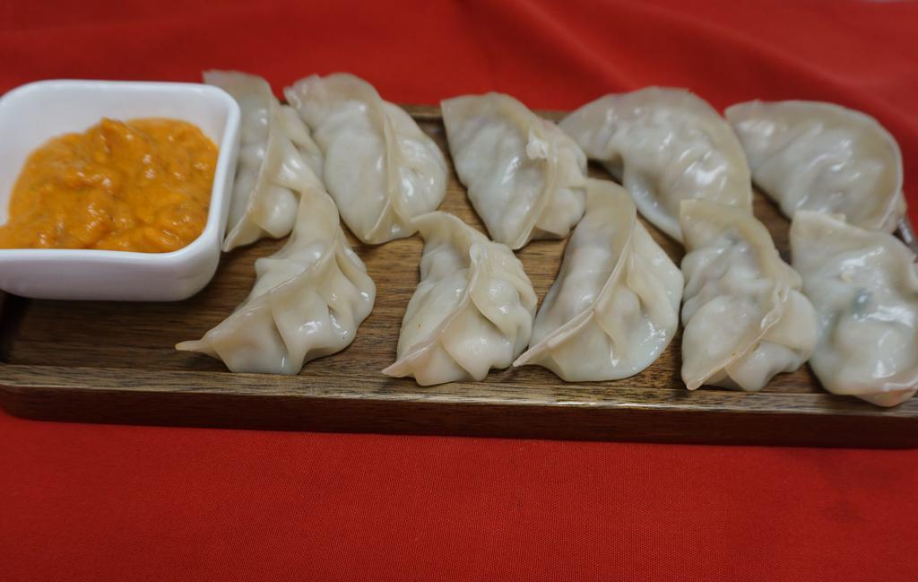 Vegetable Momo Steam/ Fried · Vegan.  (steamed/fried)..10.99(vegan) fresh vegetable mixed with minced onions, cilantro. garlic and nepali spices delicately wrapped in dough.
