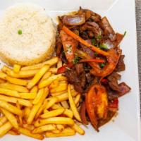 Lomo Saltado · Strips steak sautéed in oil with onions, tomato and spices. Served with fries and rice.