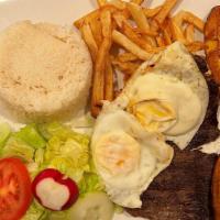 Bistec A Lo Pobre · Grilled steak. Served with French fries, fried plantains, eggs, rice, and salad.