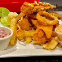 Jalea Mixta De Mariscos · Fried seafood. Marinated in our special sauce and topped with bread flour. Served with fried...